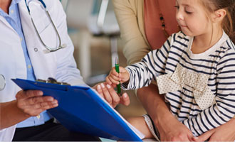 Child pointing to medical forms
